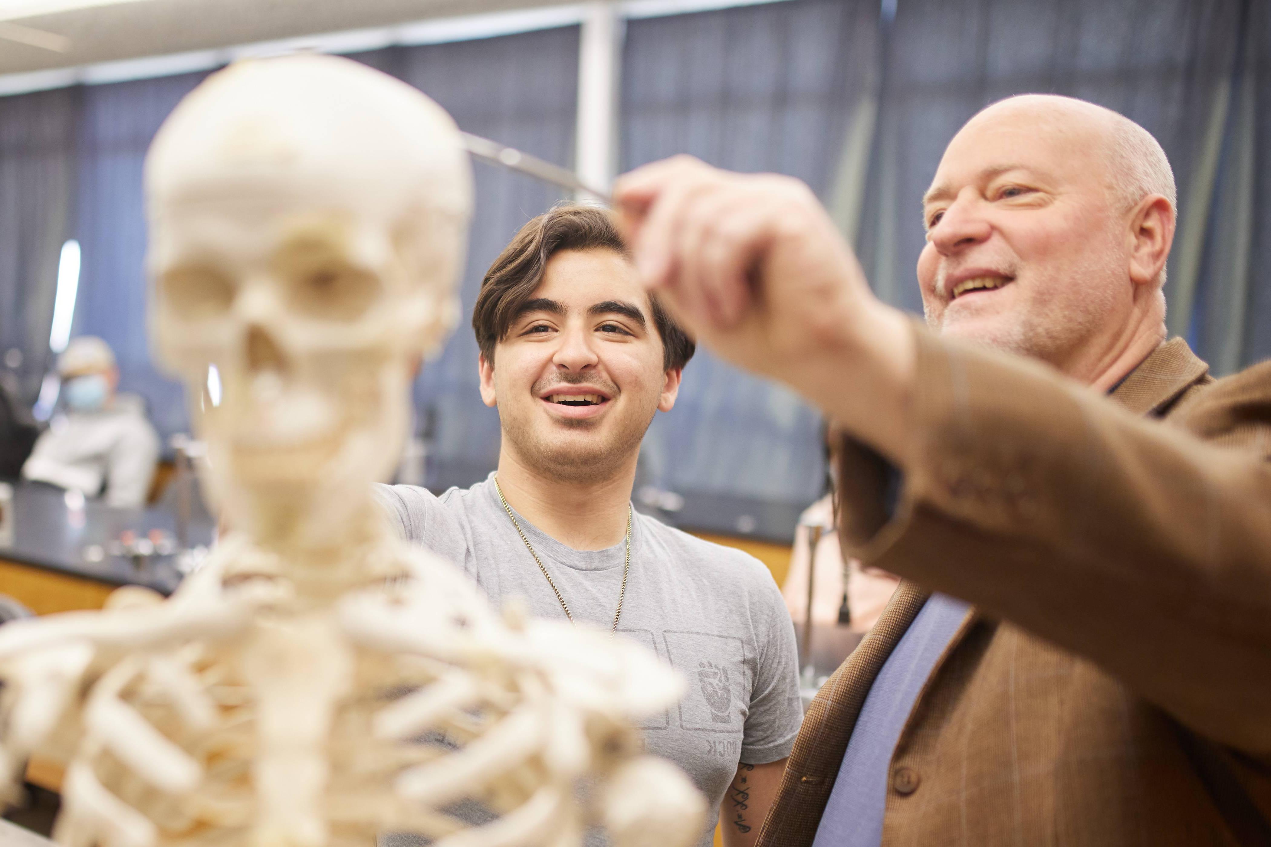 Professor pointing to skull of skeleton